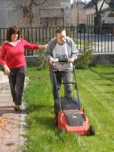 Cutting grass with assistance